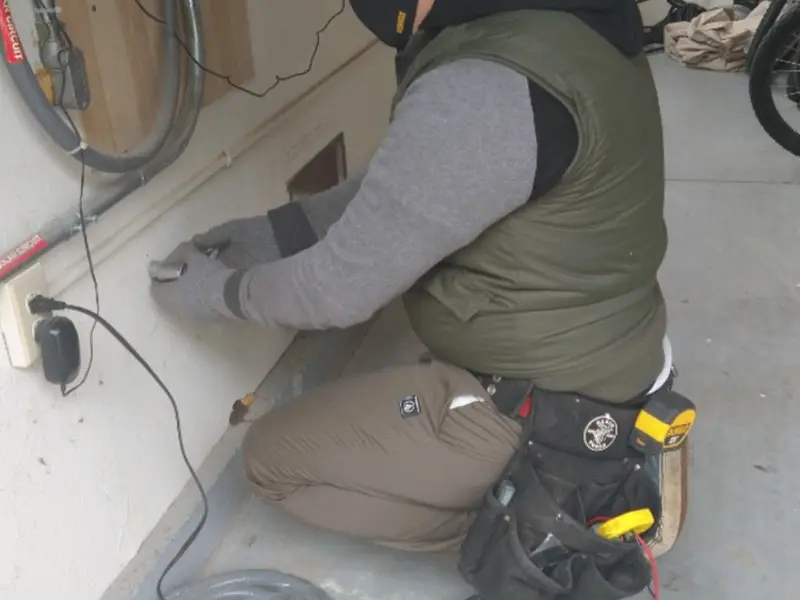 Electrician performing outlet wiring in a Key Center garage