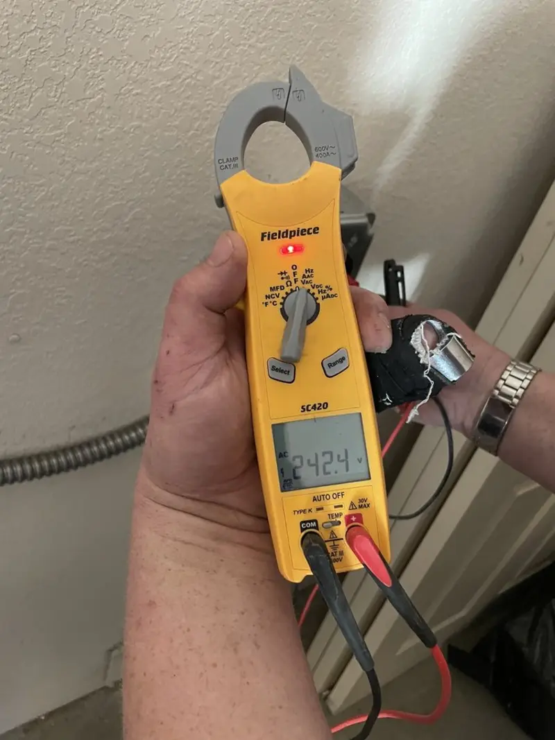 Voltage testing with clamp meter during Recessed Lighting Installation in Key Center